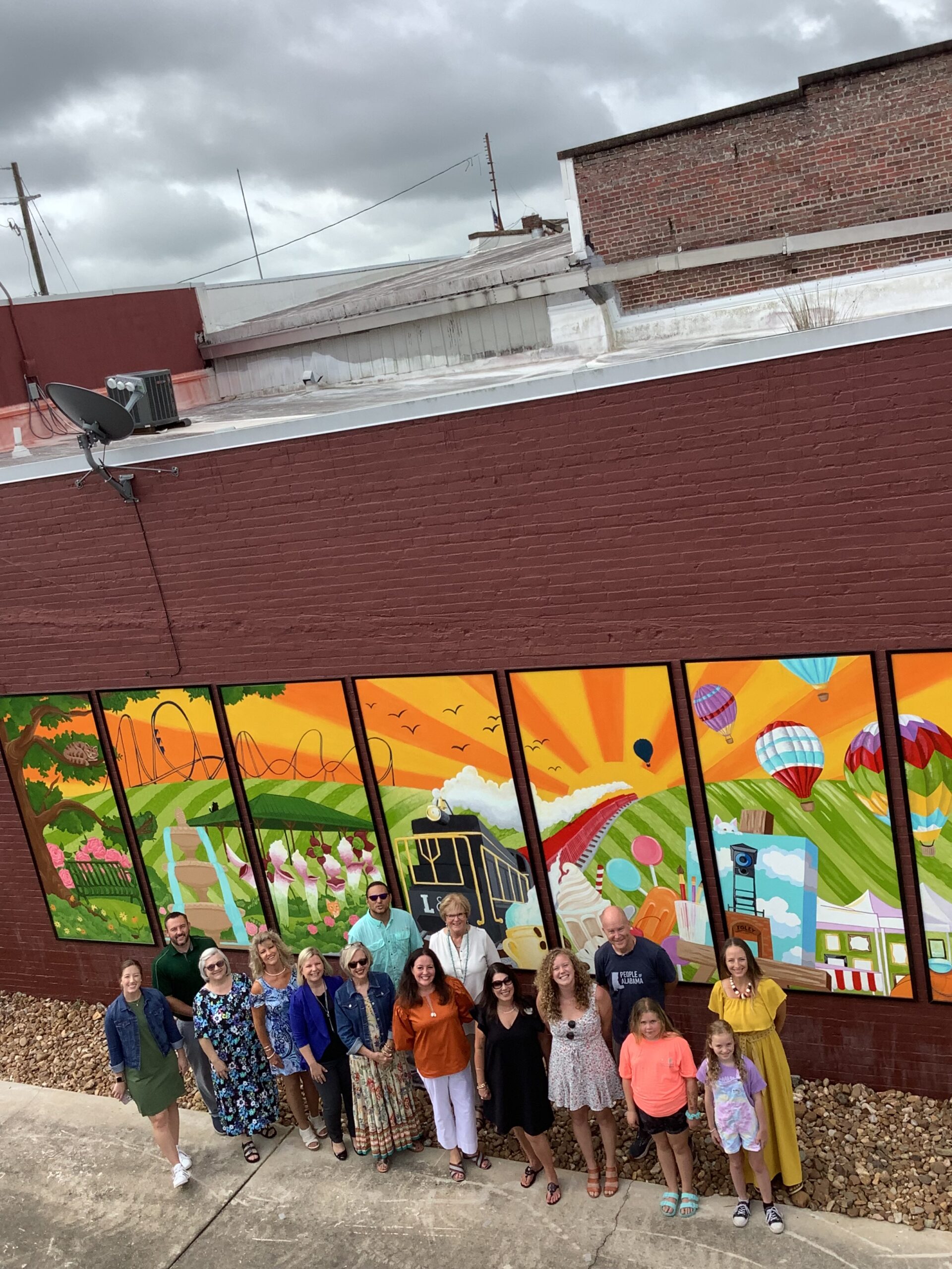 Representatives from the Foley Main Street Board, the City of Foley, the Foley Art Center, the high school, and some of the young artists joined artist Hannah Legg.