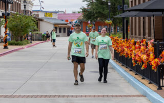 Two runners participate in Foley's Annual Ocktoberfest 5K at OWA Parks and Resorts.